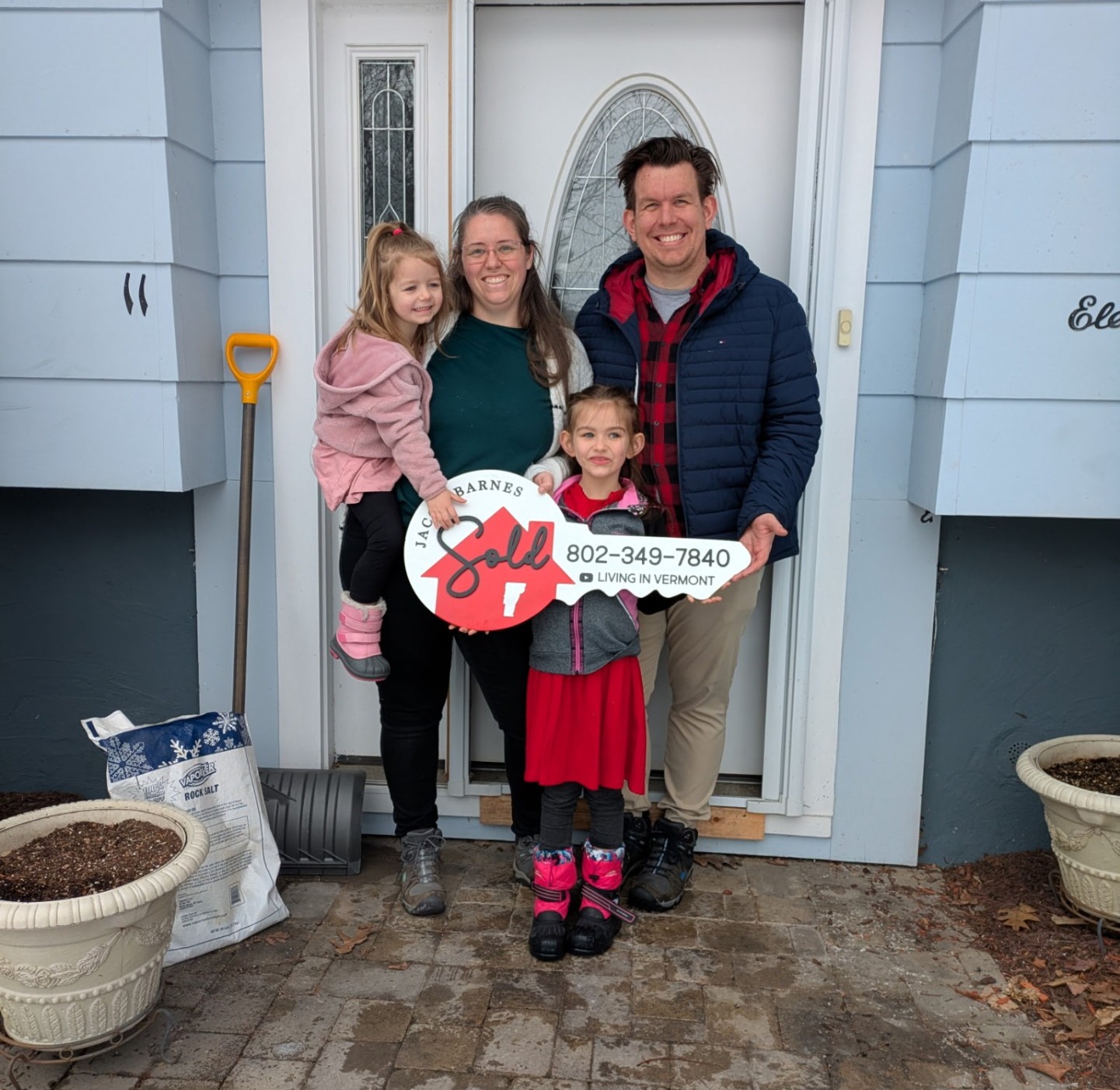 Vermont family at the front door of their new home