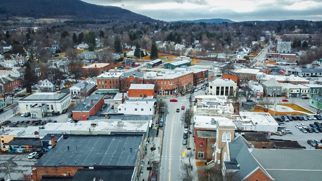 Aerial view of downtown Bennington, Vermont with historic brick storefronts and Main Street.